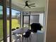 Screened patio with ceiling fan, dining table, chairs and grill at 5981 Shorebird Br, Land O Lakes, FL 34638