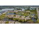 Beautiful aerial view of waterfront condos, townhomes, community pool, tennis courts, and scenic lakes at 7040 Key Haven Rd # 601, Seminole, FL 33777