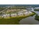 Aerial view of a tan condo complex with access to a lake, swimming pool and a nature preserve at 7040 Key Haven Rd # 601, Seminole, FL 33777