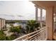 Balcony view showcasing the lake, parking lot, lush greenery, and exterior building architecture at 7040 Key Haven Rd # 601, Seminole, FL 33777