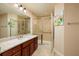 Modern bathroom featuring a glass-enclosed shower, cherry wood vanity, and stylish countertop at 7040 Key Haven Rd # 601, Seminole, FL 33777