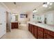 Bright bathroom featuring a double vanity and garden tub surrounded by tile at 7040 Key Haven Rd # 601, Seminole, FL 33777