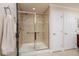 Bathroom featuring glass enclosed shower with tile surround and towel hooks at 7040 Key Haven Rd # 601, Seminole, FL 33777
