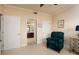 Inviting bedroom with neutral walls, plush carpeting, and a comfortable teal armchair at 7040 Key Haven Rd # 601, Seminole, FL 33777