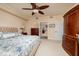Spacious bedroom featuring a ceiling fan and doorway to the adjacent bathroom at 7040 Key Haven Rd # 601, Seminole, FL 33777