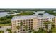 Exterior shot of the condo building displaying multiple floors and balconies for residents to relax and enjoy the views at 7040 Key Haven Rd # 601, Seminole, FL 33777
