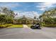 Charming clubhouse featuring landscaped grounds, palm trees, and a well-manicured lawn, perfect for gatherings at 7040 Key Haven Rd # 601, Seminole, FL 33777