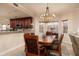 Elegant dining room featuring a stylish chandelier, wooden table, and views of the kitchen at 7040 Key Haven Rd # 601, Seminole, FL 33777