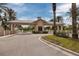 Community entrance gate featuring a covered structure and well-maintained landscaping and mature palm trees at 7040 Key Haven Rd # 601, Seminole, FL 33777