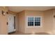 Exterior view of a condo front door with sidelight and window at 7040 Key Haven Rd # 601, Seminole, FL 33777