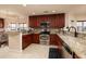 Modern kitchen featuring stainless steel appliances, granite countertops, and a breakfast bar at 7040 Key Haven Rd # 601, Seminole, FL 33777