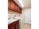 Laundry room with ample storage space above the sink and washer and dryer hookups at 7040 Key Haven Rd # 601, Seminole, FL 33777