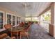 Covered patio area with wicker furniture and ceiling fans overlooking tropical grounds at 7040 Key Haven Rd # 601, Seminole, FL 33777