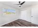 Bright bedroom featuring new floors, a large closet, and a modern ceiling fan at 7327 Jasmine Blvd, Port Richey, FL 34668