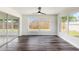 Light filled bedroom with new wood flooring and a large window overlooking the backyard at 7327 Jasmine Blvd, Port Richey, FL 34668