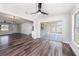Bright open living room with new floors, modern ceiling fans, and sliding glass doors with a view at 7327 Jasmine Blvd, Port Richey, FL 34668