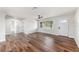 Bright living room featuring new wood flooring, a ceiling fan, and natural light from a large window at 7327 Jasmine Blvd, Port Richey, FL 34668