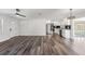 Open floorplan with a kitchen featuring stainless appliances, a new floor, and white paint at 7327 Jasmine Blvd, Port Richey, FL 34668