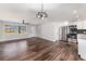 Bright living room featuring new floors, modern ceiling fans, stainless steel appliances and granite countertops at 7327 Jasmine Blvd, Port Richey, FL 34668