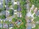 An aerial view of a neighborhood with mature trees, well-maintained homes, and community pool at 7414 Mint Julep Dr, Riverview, FL 33578
