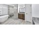 Updated bathroom features a walk-in shower, soaking tub and granite-topped vanity at 7414 Mint Julep Dr, Riverview, FL 33578