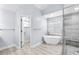 Bright bathroom featuring modern fixtures, a soaking tub, and walk-in shower at 7414 Mint Julep Dr, Riverview, FL 33578