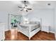 Spacious bedroom features hardwood floors, ceiling fan, and screened-in lanai access at 7414 Mint Julep Dr, Riverview, FL 33578