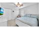 Bright bedroom with white furnishings, ceiling fan, closet, and comfortable decor at 7414 Mint Julep Dr, Riverview, FL 33578