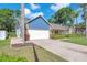 Well maintained home with a two car garage, manicured lawn, and mature landscaping enhancing its curb appeal at 7414 Mint Julep Dr, Riverview, FL 33578