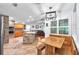 Spacious kitchen featuring a brick oven, tile floors, and wooden cabinets, flowing into an adjacent dining and living area at 7414 Mint Julep Dr, Riverview, FL 33578