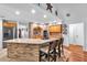 Open-concept kitchen with a brick-clad island, modern stainless steel appliances, and a vaulted ceiling adorned with star decorations at 7414 Mint Julep Dr, Riverview, FL 33578