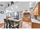 Well-lit kitchen with brick accents, a central island with bar seating, stainless steel appliances, and wood flooring at 7414 Mint Julep Dr, Riverview, FL 33578