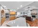 Large kitchen features a brick accent wall, stainless steel appliances, an island with a sink, and an open layout at 7414 Mint Julep Dr, Riverview, FL 33578