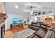 Cozy living area features hardwood floors, a brick fireplace, and a large sectional sofa at 7414 Mint Julep Dr, Riverview, FL 33578