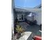 Patio with shaded seating area, garden, and sliding glass doors at 766 Bay Esplanade, Clearwater Beach, FL 33767