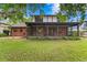 Charming home with a large screened-in porch and brick accents, perfect for outdoor living and entertaining at 7902 River Ridge Dr, Temple Terrace, FL 33637