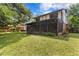 Large backyard with lush green lawn, mature trees, and plenty of space for outdoor activities at 7902 River Ridge Dr, Temple Terrace, FL 33637