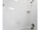 Bathroom shower with white subway tile, corner shelving, and updated hardware at 7902 River Ridge Dr, Temple Terrace, FL 33637
