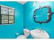Vibrant bathroom showcases a unique mirror, sink, toilet, and a window for natural light at 7902 River Ridge Dr, Temple Terrace, FL 33637