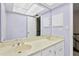 Bathroom with a double sink vanity, a large mirror, and neutral paint at 7902 River Ridge Dr, Temple Terrace, FL 33637
