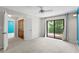 Bedroom with carpet, ceiling fan, stained glass closet doors and sliding door to a balcony at 7902 River Ridge Dr, Temple Terrace, FL 33637