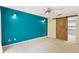 Bedroom with blue accent wall and sliding barn door for closet or bathroom access at 7902 River Ridge Dr, Temple Terrace, FL 33637