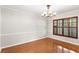 Dining area showcasing hardwood floors, chair rail detail and lovely window shutters at 7902 River Ridge Dr, Temple Terrace, FL 33637