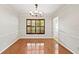 Formal dining room boasts hardwood floors, decorative lighting, and access to a sunlit entryway at 7902 River Ridge Dr, Temple Terrace, FL 33637