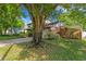 Beautiful exterior showing lawn, mature trees and attached carport at 7902 River Ridge Dr, Temple Terrace, FL 33637