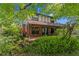 Charming brick home with a Tudor-style accent and covered front porch, surrounded by lush landscaping at 7902 River Ridge Dr, Temple Terrace, FL 33637