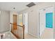 Upstairs hallway with carpet floors and stained glass features on a stairwell window at 7902 River Ridge Dr, Temple Terrace, FL 33637