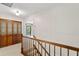 Second floor hallway with decorative wooden doors and a stairway with wood banister at 7902 River Ridge Dr, Temple Terrace, FL 33637
