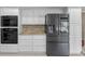 Kitchen with sleek stainless steel refrigerator, double oven, and ample cabinet space at 7902 River Ridge Dr, Temple Terrace, FL 33637