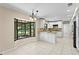 Eat-in kitchen featuring white cabinetry, granite countertops, stainless steel appliances, and a bay window at 7902 River Ridge Dr, Temple Terrace, FL 33637